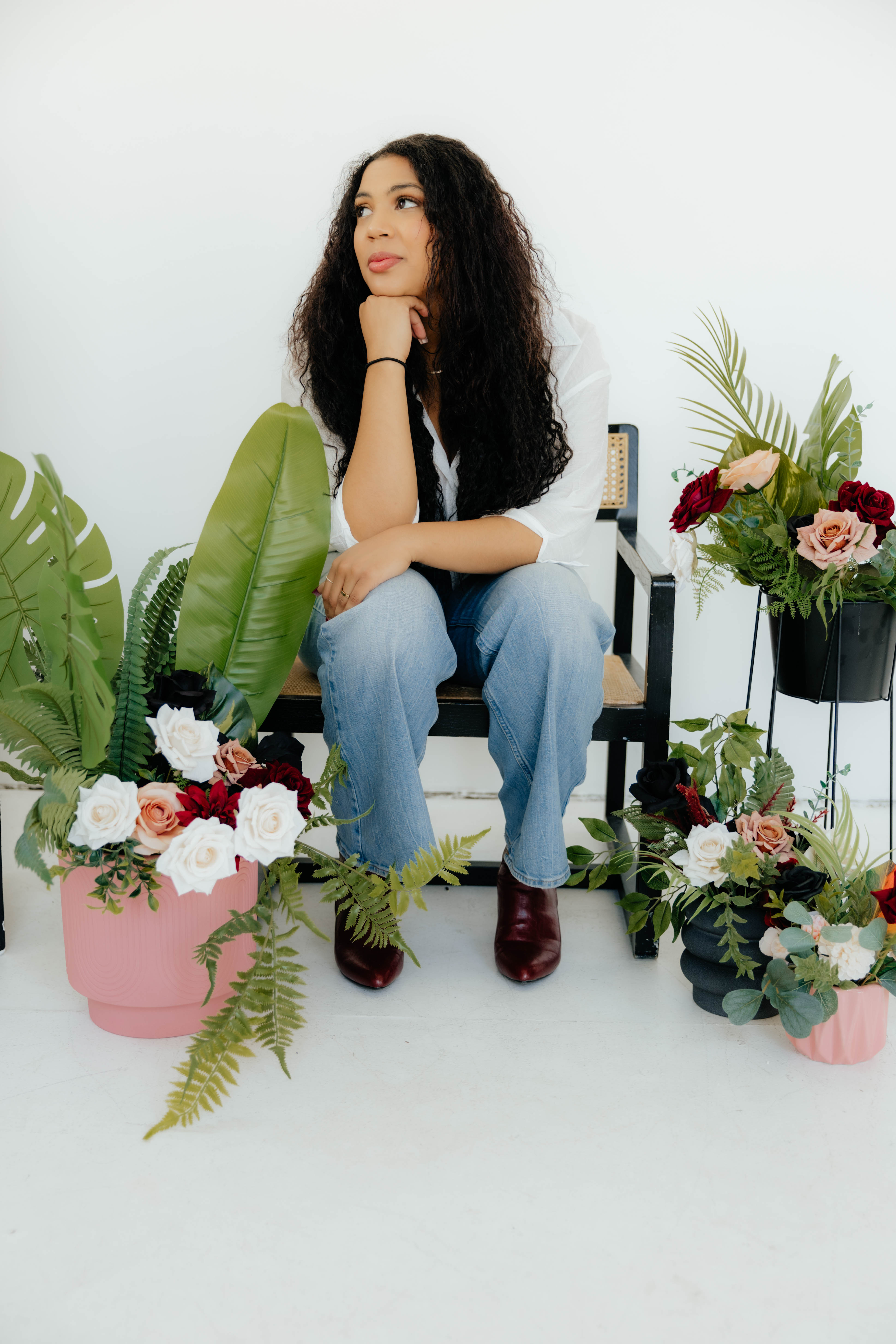 Ali seated among silk arrangements
