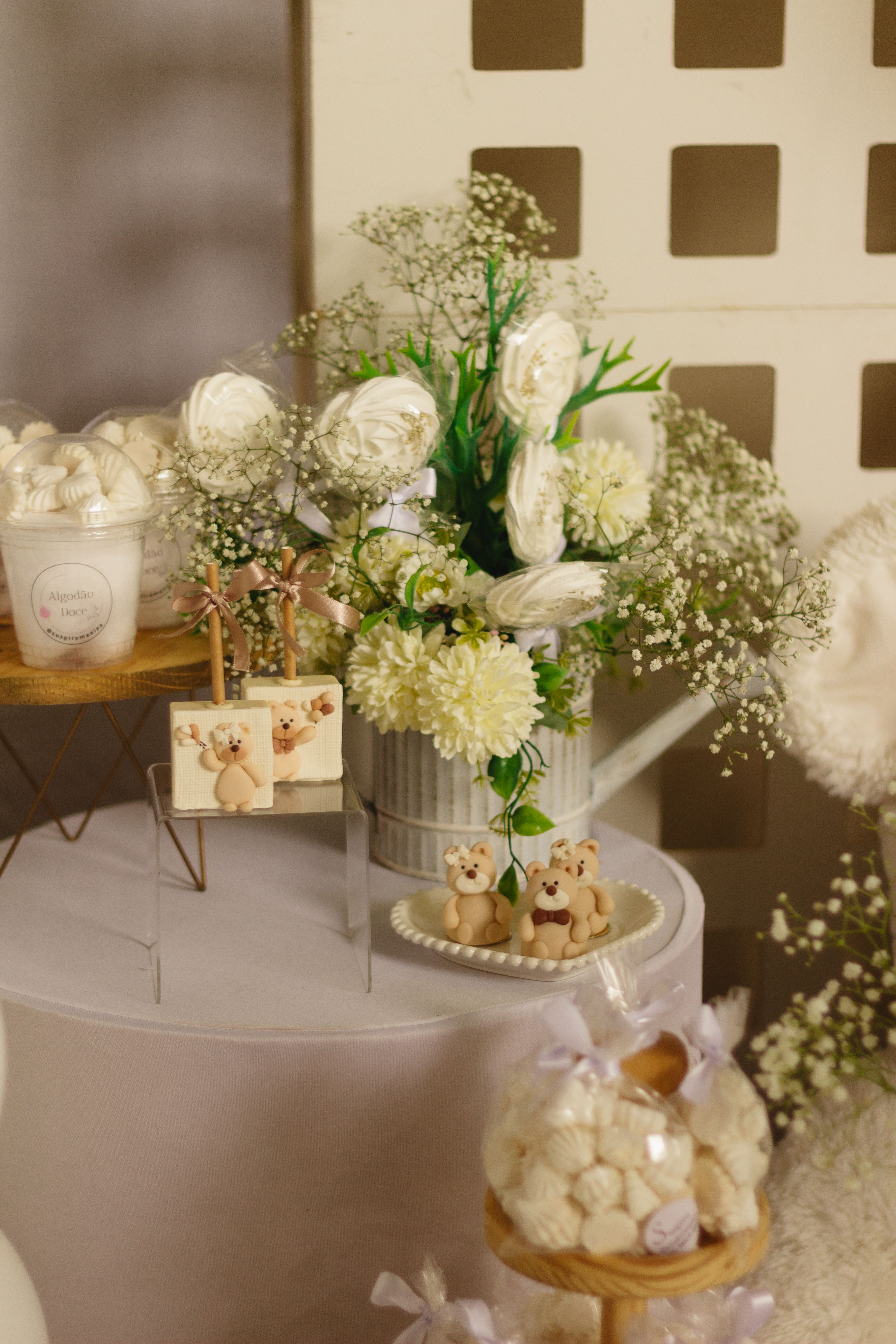 Ivory dessert table with white florals and favors