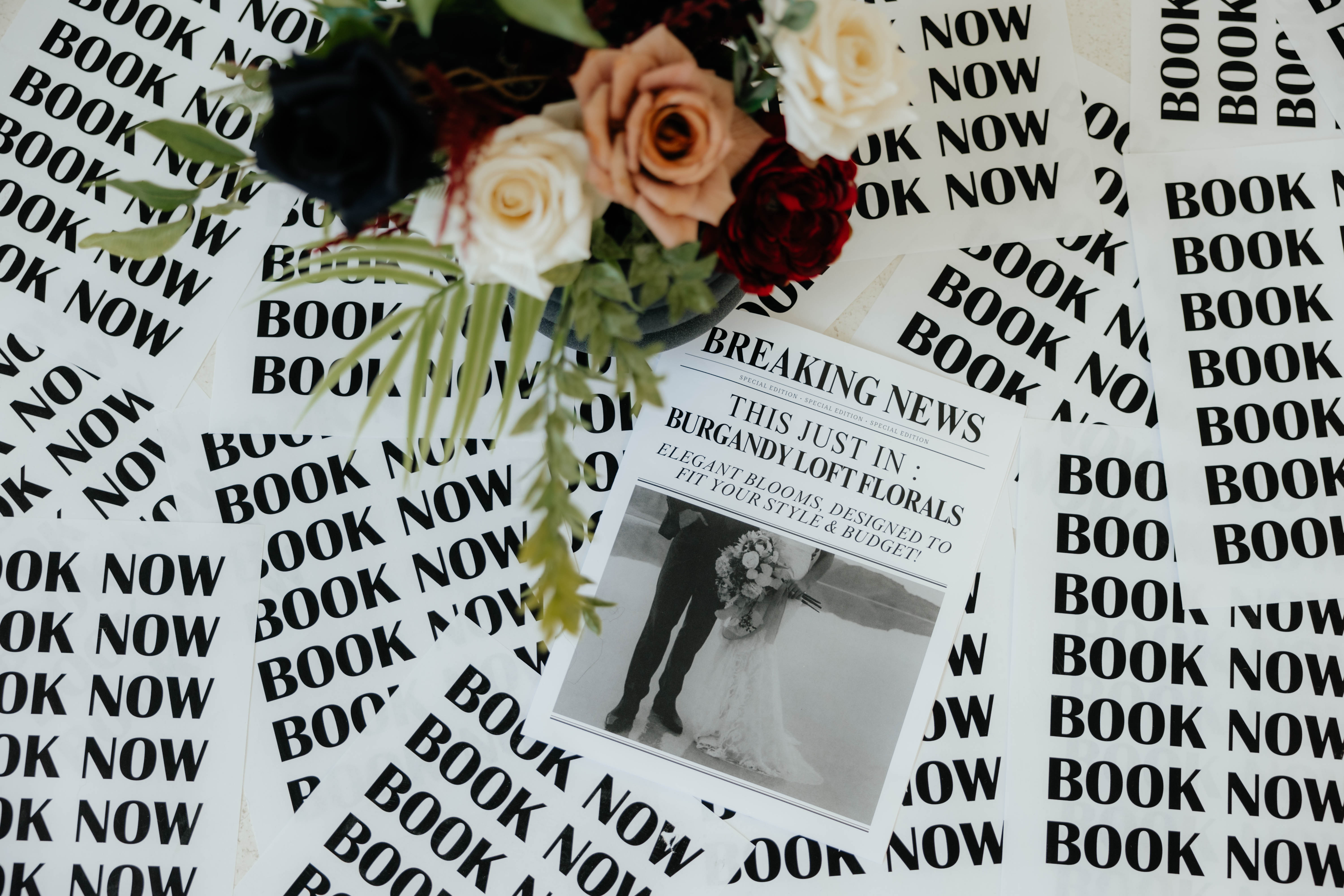 Editorial flat lay of blooms and printed collateral